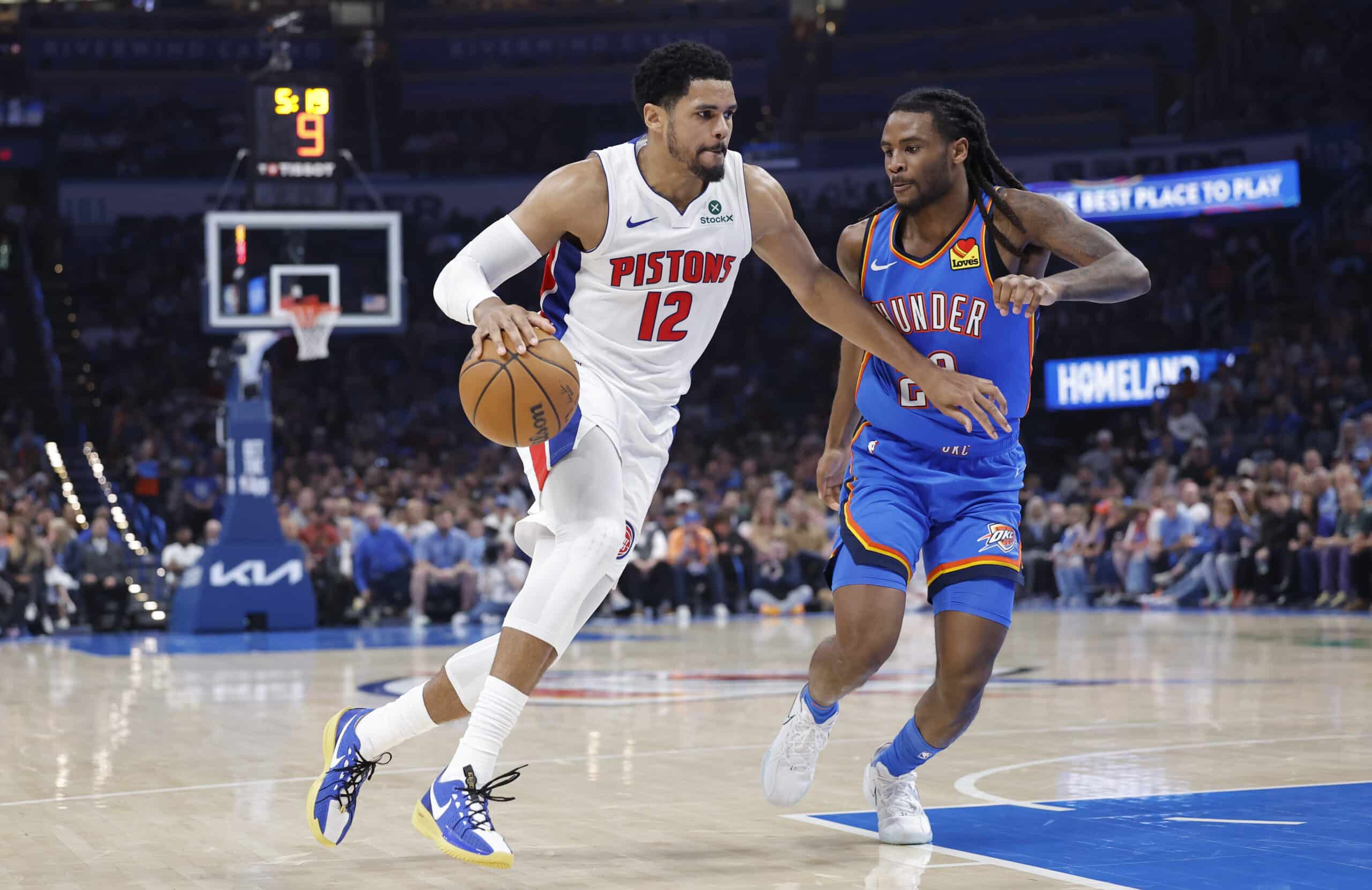 Apr 2, 2025; Oklahoma City, Oklahoma, USA; Detroit Pistons forward Tobias Harris (12) drives around Oklahoma City Thunder guard Cason Wallace (22) during the second quarter at Paycom Center. Mandatory Credit: Alonzo Adams-Imagn Images